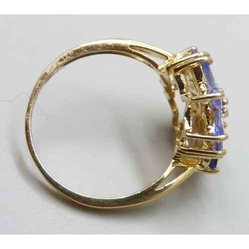 7044 - A 9ct gold ring set with purple stones, 3.2g, P