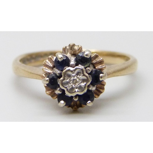 7050 - A 9ct gold, sapphire and diamond cluster ring, 2.6g, J/K