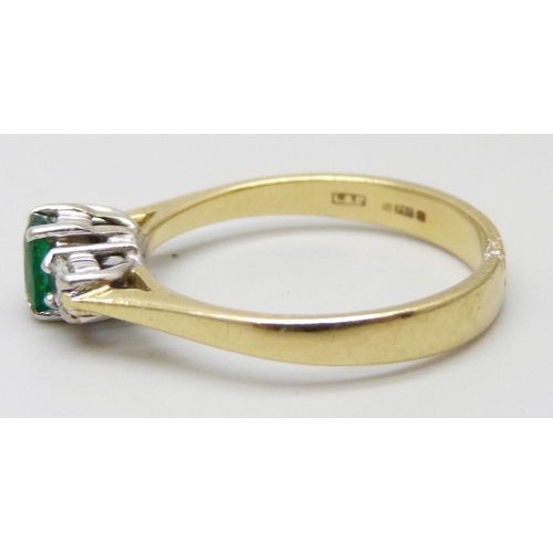 7059 - An 18ct gold, diamond and emerald ring, 2.9g, M