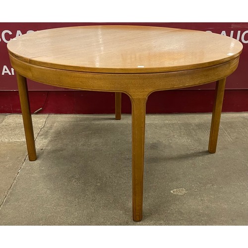 47 - A Nathan teak circular extending dining table