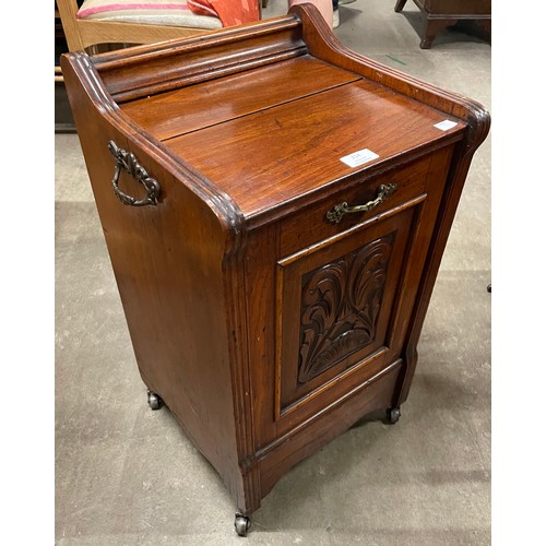 214 - A Victorian carved walnut purdonium