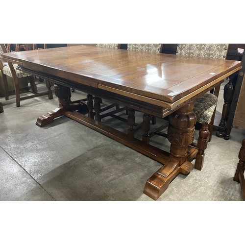 228 - A 17th Century style oak extending refectory table and six chairs