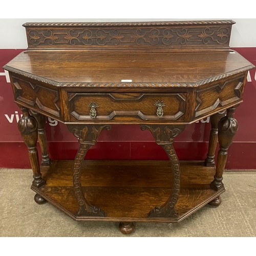 229 - A 17th Century style carved oak single drawer console table