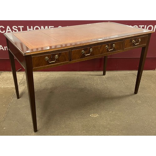 230 - A George III style mahogany and red leather topped three drawer library table