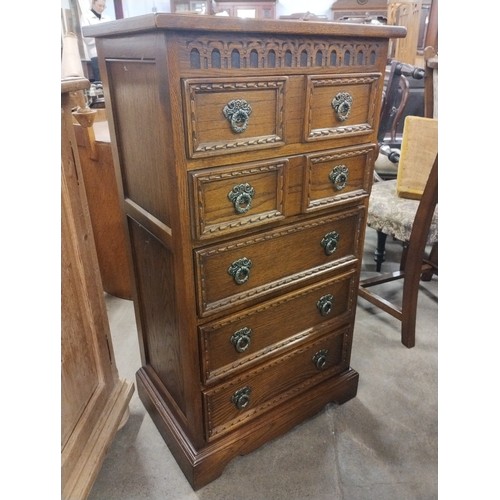 308 - A 17th Century style carved oak chest of drawers