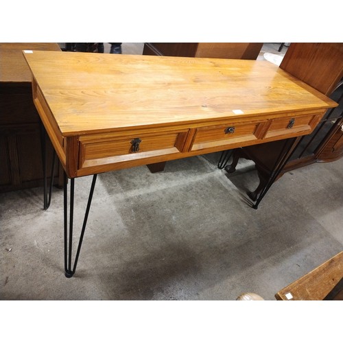 312 - A pine three drawer hall table, on hairpin legs