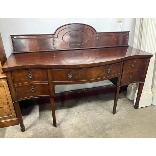320 - An Edward VII mahogany serpentine sideboard