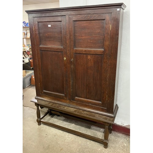 321 - A George III oak two door bookcase on later stand