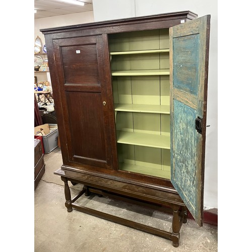 321 - A George III oak two door bookcase on later stand