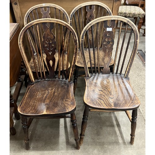 334 - A set of four early 20th Century elm and beech wheelback chairs