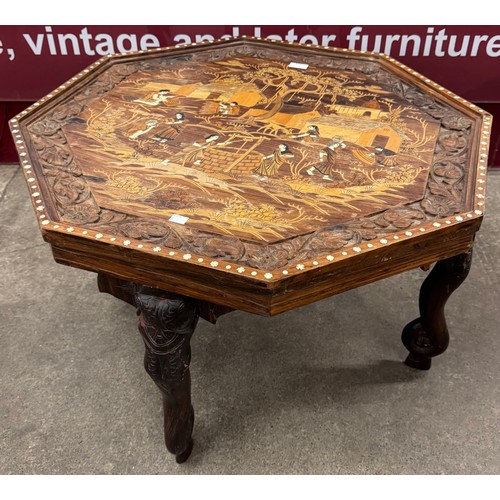 185 - An Eastern carved hardwood and faux ivory inlaid octagonal coffee table