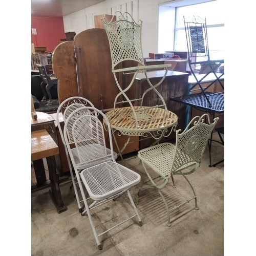 352 - A French style cast alloy folding garden table and two pairs of folding chairs