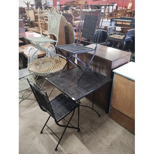 353 - A black metal garden table and two folding chairs