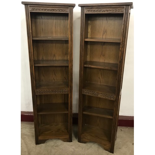 200 - A pair of tall 17th Century style carved oak open bookcases