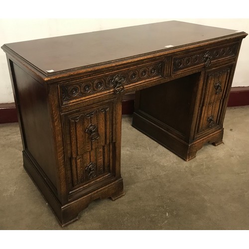 201 - A 17th century style carved oak linenfold dressing table