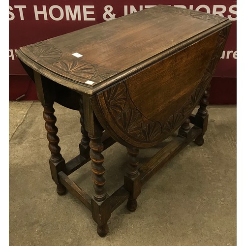 203 - An early 20th Century carved oak barleytwist gateleg table