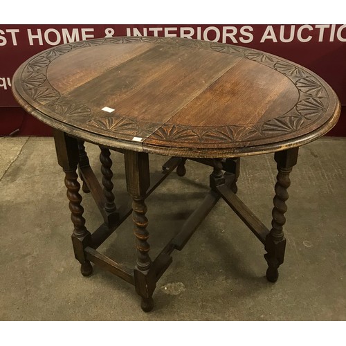 203 - An early 20th Century carved oak barleytwist gateleg table