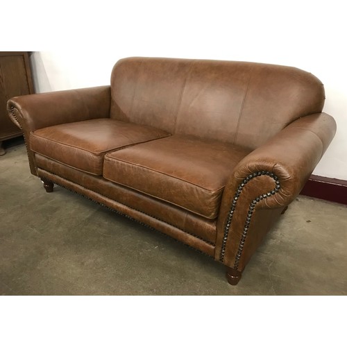 227 - A Victorian style brown leather two seater settee