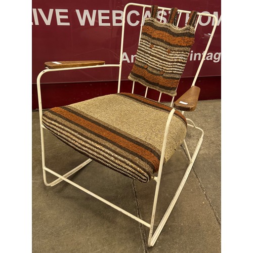 65 - A Race Furniture teak and white painted tubular metal rocking chair, designed by Ernest Race
