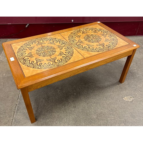 67 - A Danish teak and tiled top rectangular coffee table