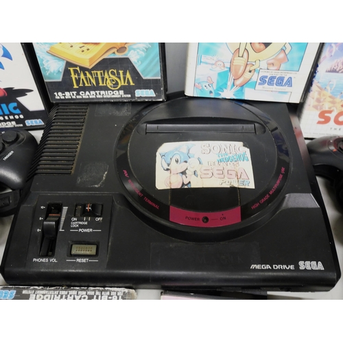 2109 - A Sega Mega Drive together with games including Sonic, Fantasia, Pac Mania, etc., with controllers