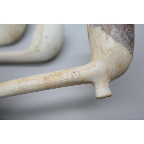 2174 - A clay pipe marked For Auld Lang Syne and three other pipes, (‘three others’ a/f)