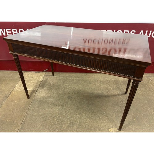 113 - A late Victorian Howard & Sons mahogany two drawer writing table