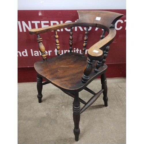 165 - A Victorian elm and beech smokers bow armchair