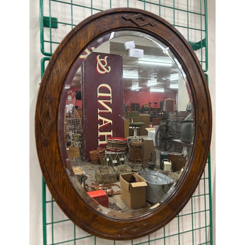 342 - An oak framed bevelled mirror