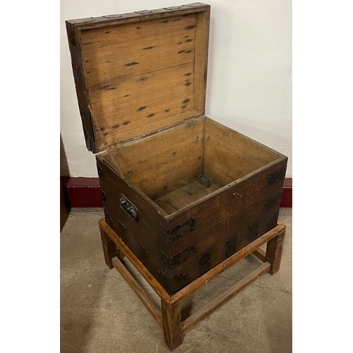122A - An early 20th Century oak and iron mounted silver chest, on later stand