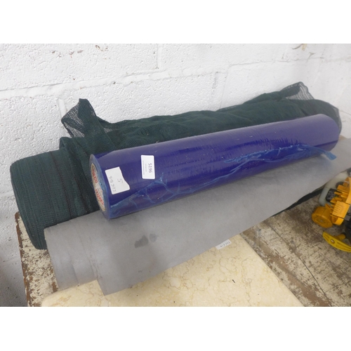 5196 - A large roll of green net, roll of blue wrap and roll of grey weed membrane