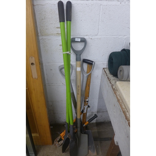 5200 - An assortment of tools, pick axe, posthole digger, shovels, etc.