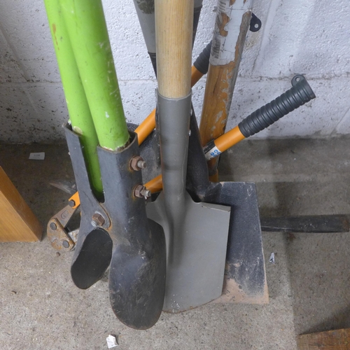 5200 - An assortment of tools, pick axe, posthole digger, shovels, etc.