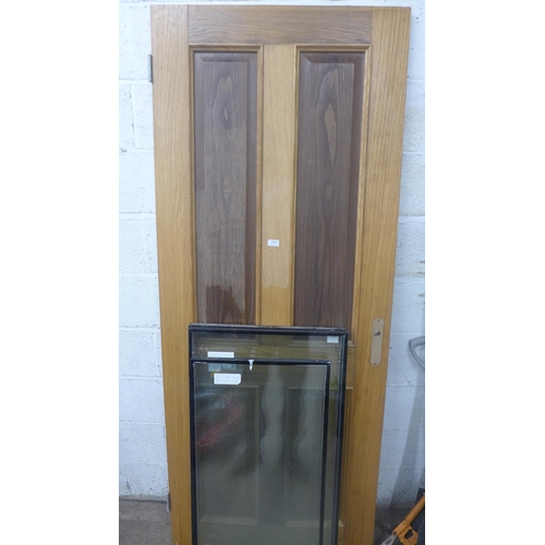 5201 - An 80 x 205cm oak door and 3 panes of glass