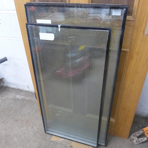 5201 - An 80 x 205cm oak door and 3 panes of glass