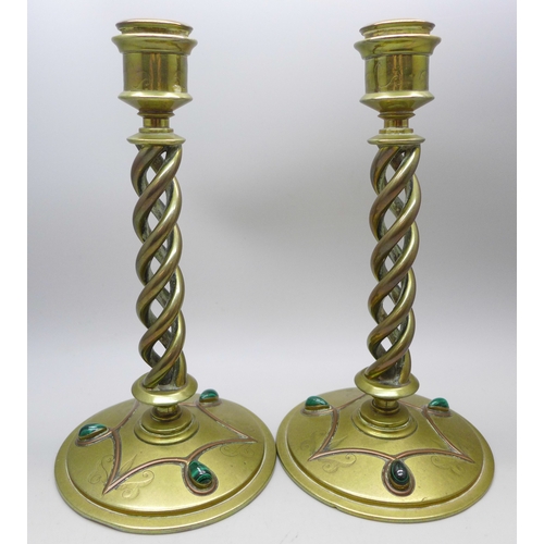 2069 - A pair of Victorian Gothic Revival brass open-twist candlesticks, each set with three cabochon malac... 