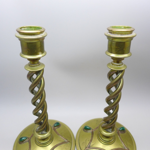 2069 - A pair of Victorian Gothic Revival brass open-twist candlesticks, each set with three cabochon malac... 