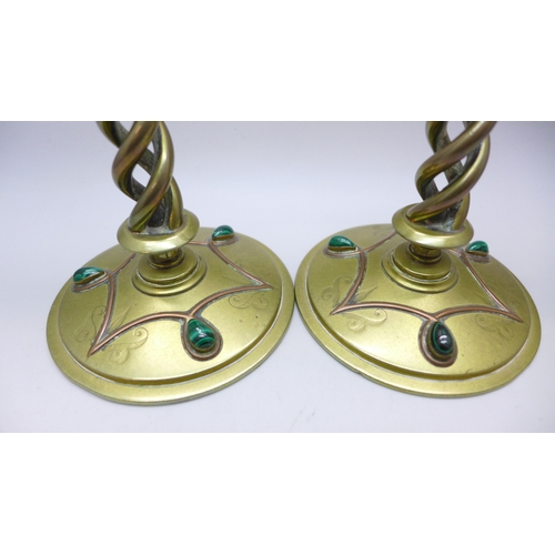2069 - A pair of Victorian Gothic Revival brass open-twist candlesticks, each set with three cabochon malac... 