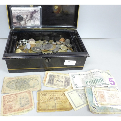 2111 - A tin money box, containing various coins and bank notes