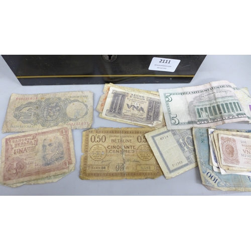 2111 - A tin money box, containing various coins and bank notes