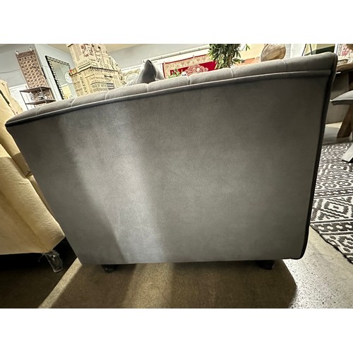 3037 - A dark grey velvet upholstered 2 seater sofa