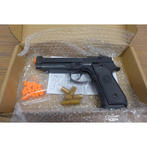 5078 - A toy spring loaded Berretta M92 toy gun and a box of various household items including stuffed elep... 