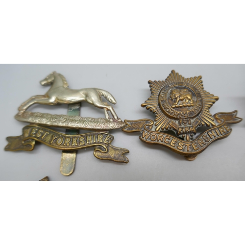 2121 - Twelve assorted military vintage cap badges