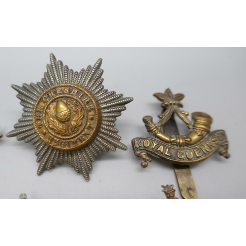 2121 - Twelve assorted military vintage cap badges