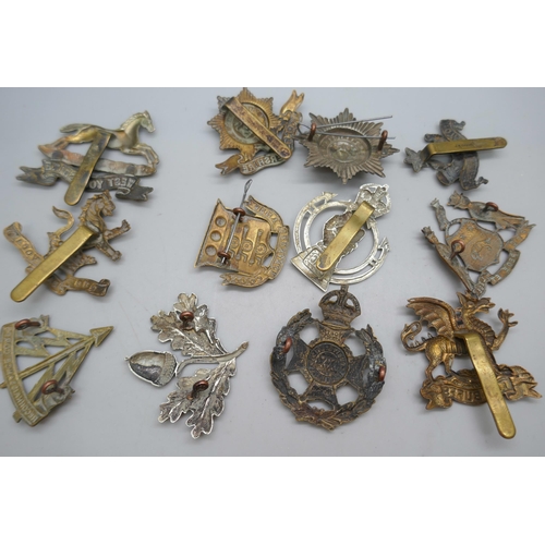 2121 - Twelve assorted military vintage cap badges