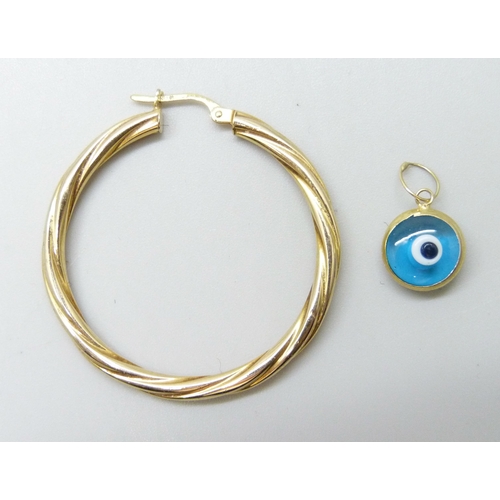 7061 - A 9ct gold hoop earring and a yellow metal framed eye pendant, 2.3g total weight