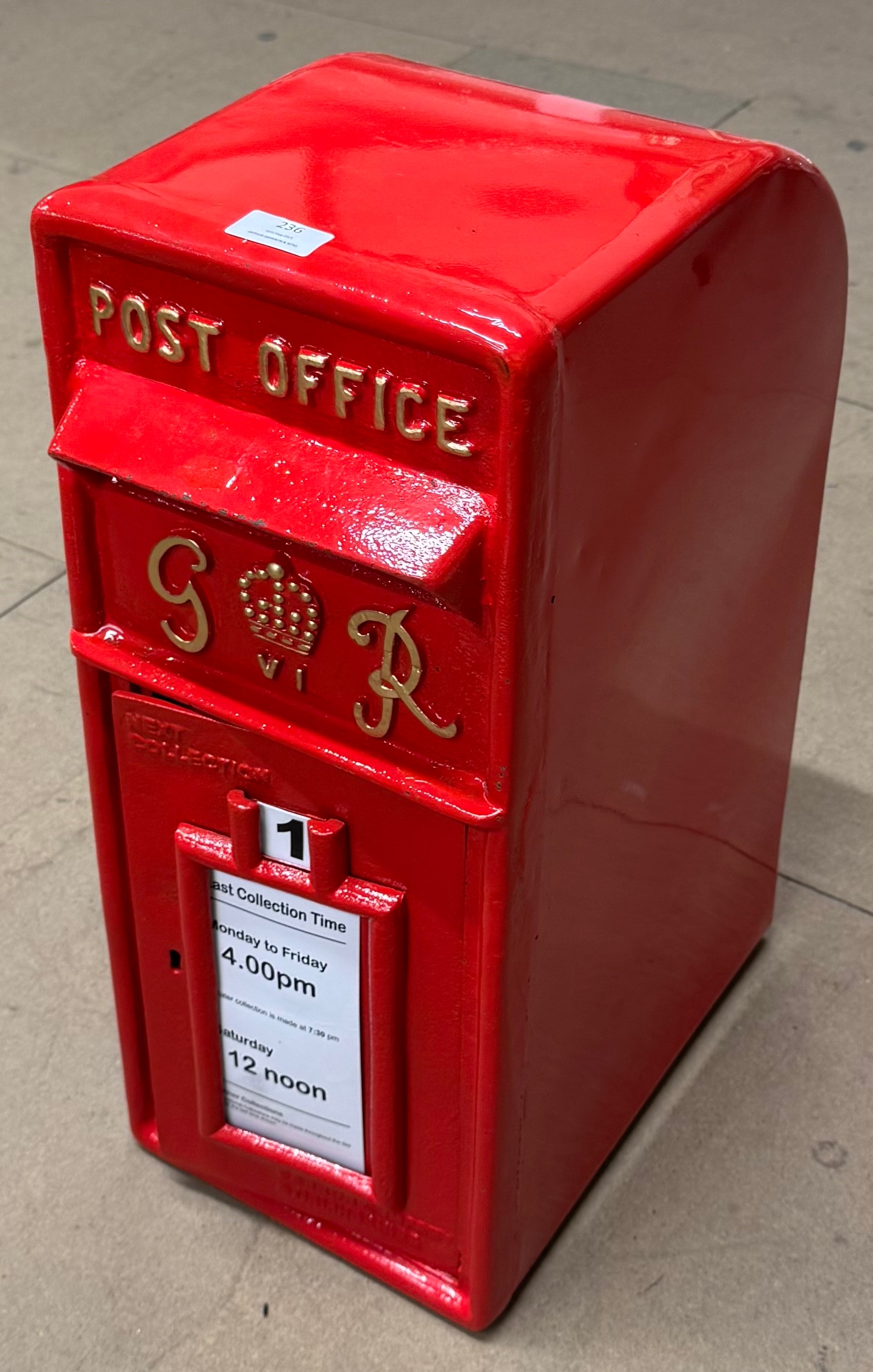 A red painted cast iron Royal Mail postbox
