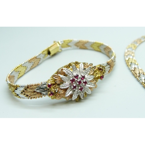 7003 - A silver multi-tone chevron link jewellery set comprising of a necklace, a bracelet and a pair of ea... 