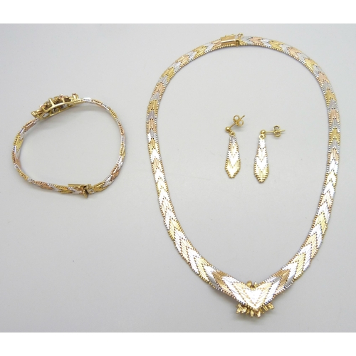 7003 - A silver multi-tone chevron link jewellery set comprising of a necklace, a bracelet and a pair of ea... 