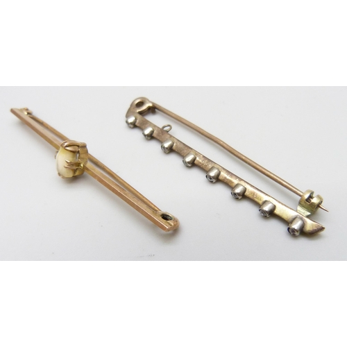 7009 - A 9ct gold bar brooch set with a tooth (2g) and another bar brooch